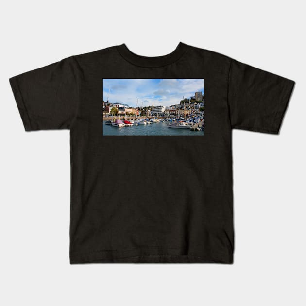 A sunny view across the boats moored in the harbour of the Devonshire seaside town of Torquay. Kids T-Shirt by Graz-Photos